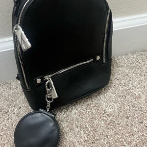 A mini backpack fits cellphone and small wallet and keys . Also compact mirror